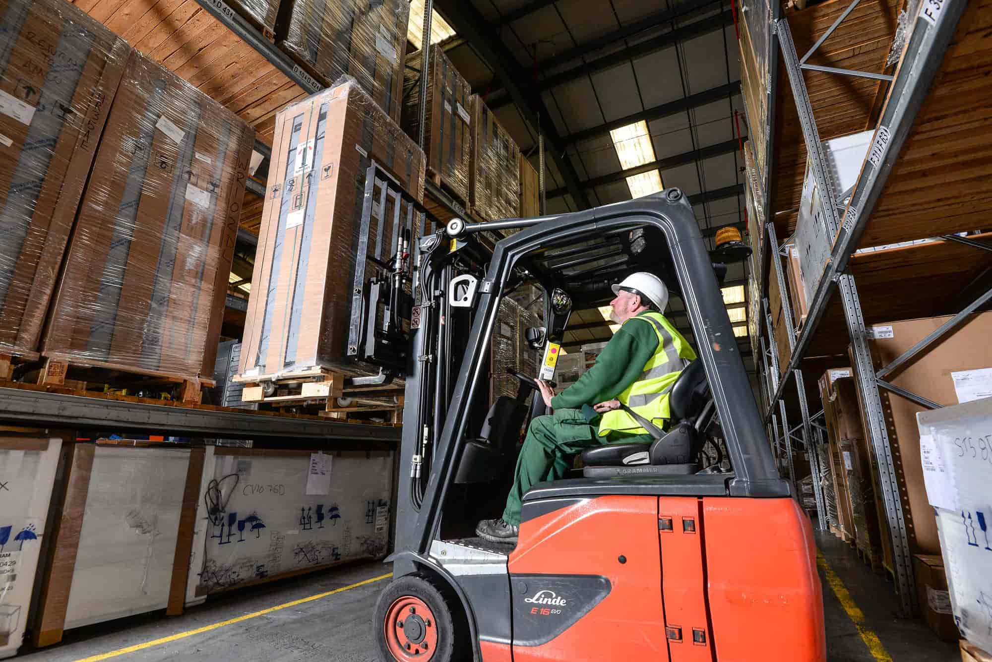 Man in warehouse selecting a parcel