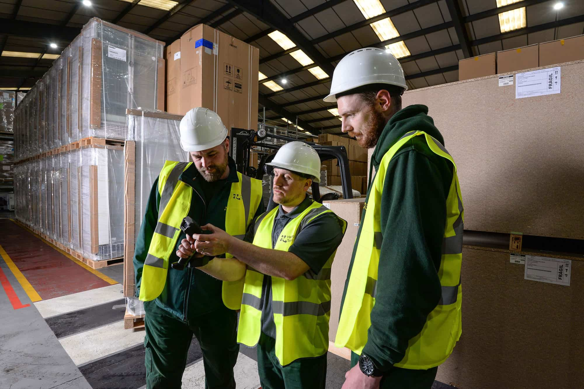 Three colleagues working in a warehouse