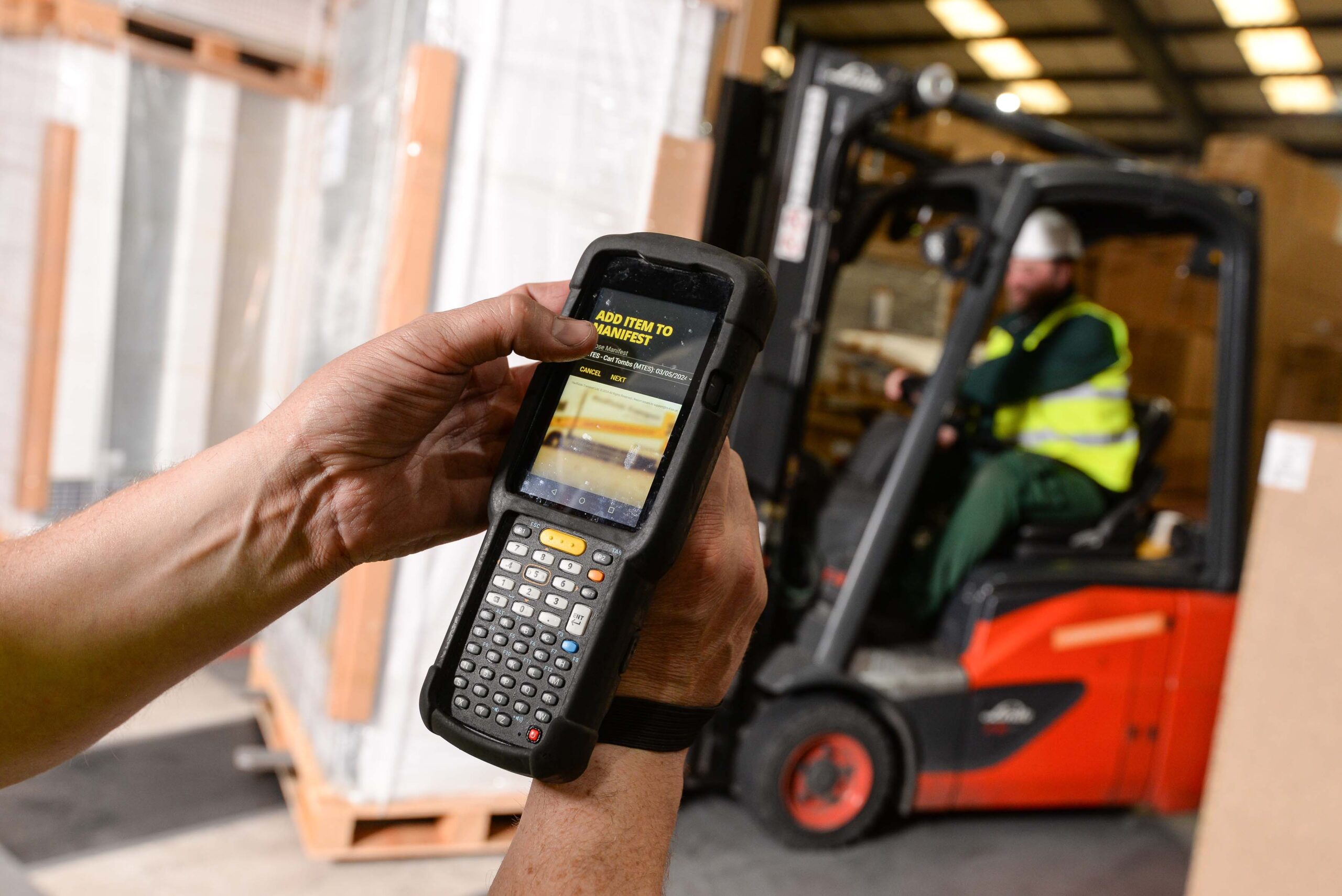 Warehouse technology with worker in background